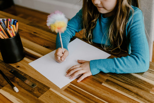 Child writing at bedtime to express emotions