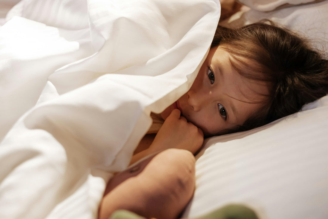 child scared at night in bed soft light