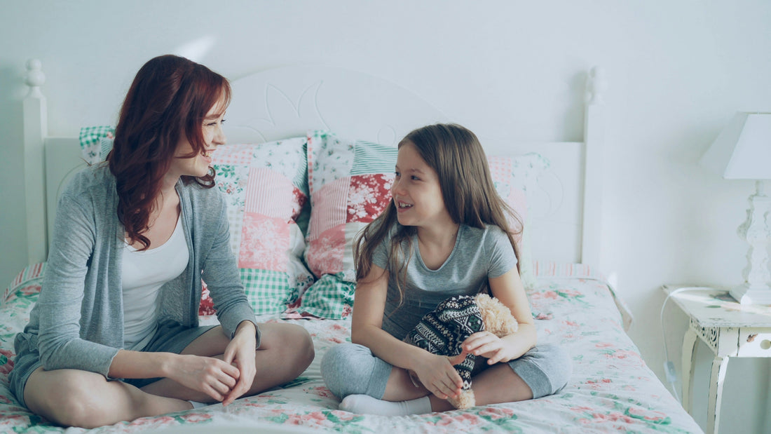 Parent listening to child talk about a bad dream at bedtime